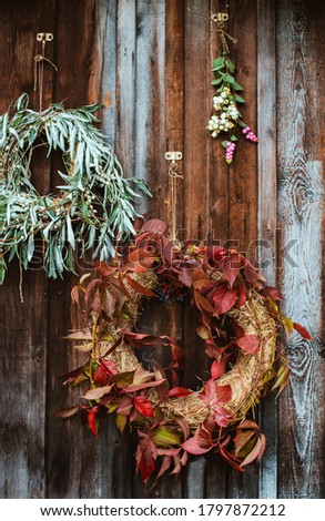 Fall front porch. autumn wreath and pumpkins on old wooden rustic background at doors. autumn composition and copy space for text