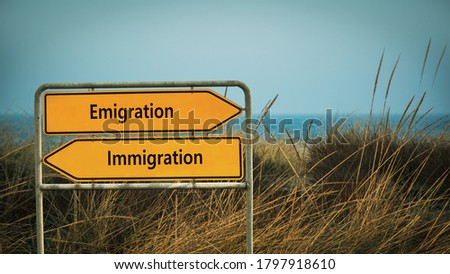 Street Sign the Direction Way to Emigration versus Immigration Royalty-Free Stock Photo #1797918610