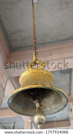 Close up view of a hanging bell or Ghanta in a temple. Sign to exhort Hindu God. Traditional Vedic religion rituals.