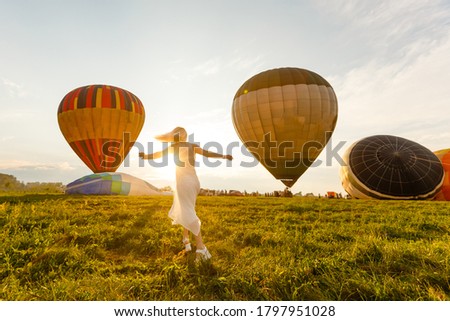 Amazing view with woman and air balloon. Artistic picture. Beauty world. The feeling of complete freedom