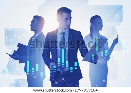 Three business people working with documents in blurry abstract city with double exposure of financial charts. Toned image
