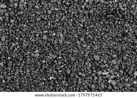 Gray small rocks ground texture. black small road stone background. gravel pebbles stone seamless texture, marble. dark background of crushed granite gravel, close up. grey clumping clay Royalty-Free Stock Photo #1797971461
