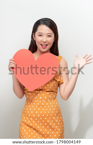 Young woman with red heart isolated on white background