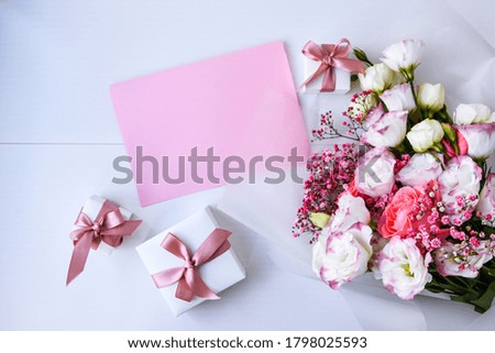 card mockup with delicate bouquet and gift boxes. floral background. Top view Flat lay Holiday card 8 March, Happy Valentine's day, Mother's day concept. Copy space for text. Holiday greeting card
