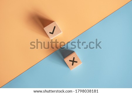True and false symbols accept rejected for evaluation, Yes or No on wood blogs on blue and yellow background. Royalty-Free Stock Photo #1798038181