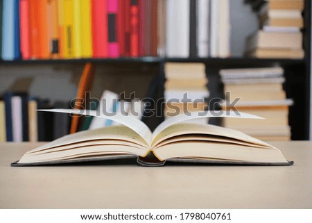 An open book on a desk in the library