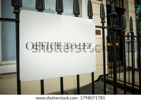 'Office To Let' sign on city street