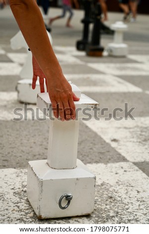 Wooden chess pieces on the asphalt. Game outdoor. 