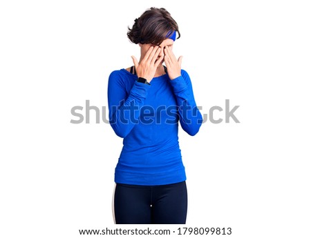Beautiful young woman with short hair wearing training workout clothes rubbing eyes for fatigue and headache, sleepy and tired expression. vision problem 