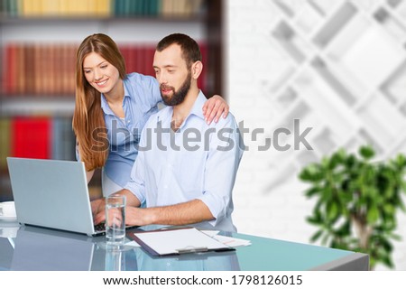 Pleasant family couple sitting and looking at the laptop screen. Royalty-Free Stock Photo #1798126015