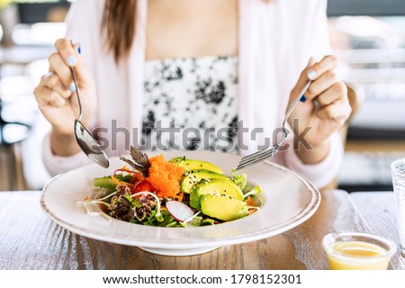 Young woman eating healthy salad at restuarant, Healthy lifestyle, diet concept