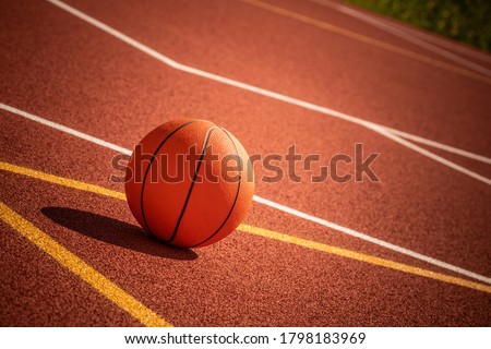 Ball left unattended on the outdoor basketball court