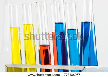 Science laboratory research and development. Modern biochemistry industry mockup. Close up test tubes with color liquid on white background. Chemical manufacture concept with glass equipment.