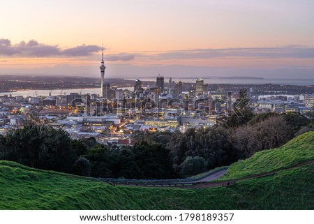 Auckland city skyline with Auckland Sky Tower from Mt. Eden at sunset New Zealand Royalty-Free Stock Photo #1798189357