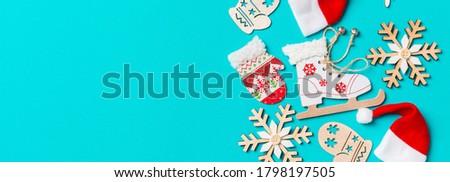 Top view Banner of Christmas decorations and Santa hats on blue background. Happy holiday concept with copy space.