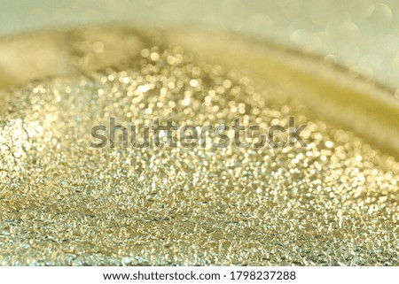  Gold blurred glittering background. Shiny yellow surface. Shallow depth of light.