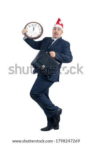 Comic image of a man in a suit and a Santa hat with a big clock five minutes before the New Year - Concept on the topic of time management and preparation for the New Year