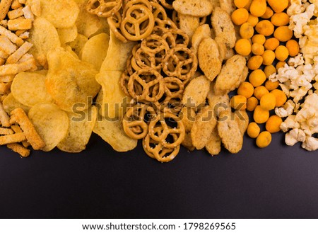 
Junk food. A lot of junk food on a black background.
Copy space.