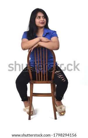 portrait of a latein woman  sitting on a chair in white background, look side