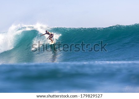surfing a wave Royalty-Free Stock Photo #179829527
