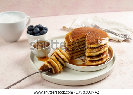 eating pancakes with caramel syrup Royalty-Free Stock Photo #1798300942