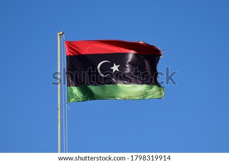 National flag of Libya in strong wind Royalty-Free Stock Photo #1798319914