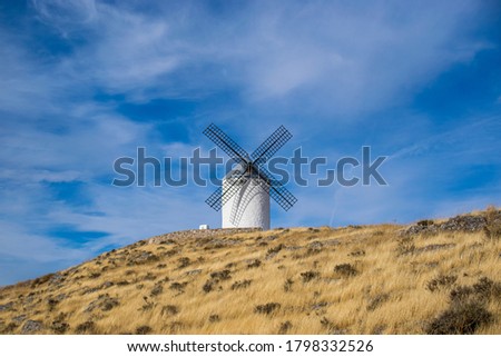 Photo of some beautiful and historical windmills located in Consuegra, Toledo, Spain during a sunny day of summer in a natural place. 