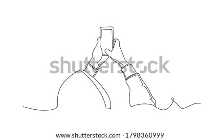 Man in a hoodie taking photo with smartphone one line drawing. Side view. Man standing with smartphone continuous line drawing. vector illustration.
