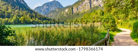 Beautiful lake Thumsee in Alpine mountains. Popular walking trail in summer sunny day, banner. Berchtesgaden National Park, Germany.