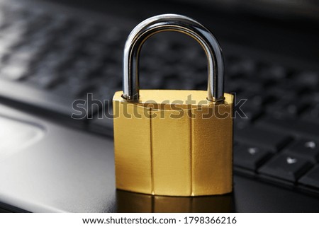 golden padlock on a black laptop keyboard over white background. internet security concept. antivirus software concept. electronic wallet symbol.