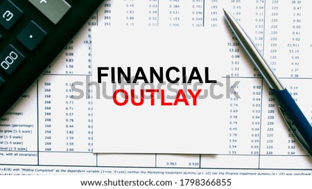 Work smarter text Financial Outlay on white sheet with pen, calculator and tables. Business and financial conzept
