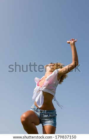 young woman in jeans shorts in the summertime