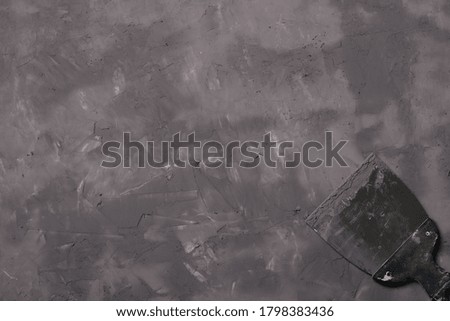 Making a background dark gray concrete with a spatula copy space for design or text, horizontal format