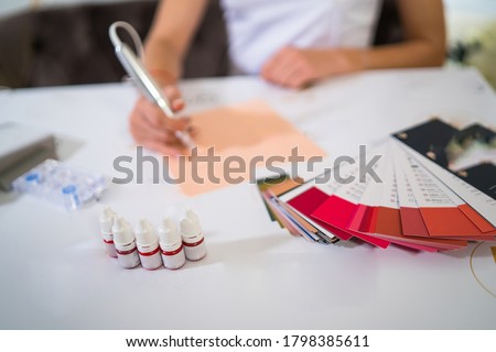 Bottles with colorful red inks for permanent tattoo. Professional permanent tatoo training materials. Close up. Royalty-Free Stock Photo #1798385611