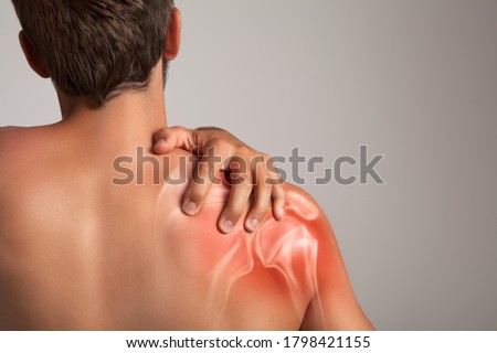 Shoulder pain, man holding a hand on a painful zone Royalty-Free Stock Photo #1798421155