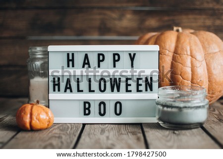 Halloween holiday concept. Pumpkin. Autumn mood. Happy Halloween. White lightbox on the wooden table with autumn background.