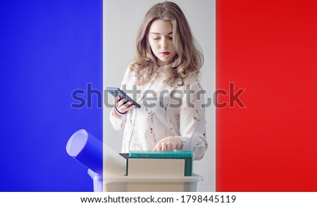 Dismissal. France woman lost job. Flag of France. Woman next to box. Concept - unemployed woman from France. woman is looking for work on phone. Office supplies are in box. Depression due to dismissal
