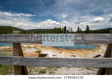 Black Opal spring, located in the Biscuit Basin, a geothermal feature area of Yellowstone National Park - sign