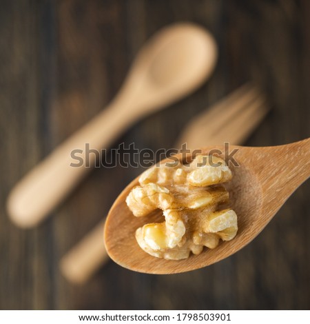 A wooden spoon on a black wooden table