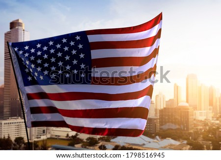 American flag waving in the air with cityscapes. Happy Labor Day