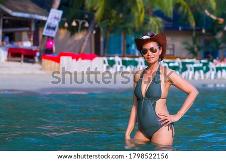 Woman body big pretty with swimsuit at beach Koh Chang Thailand.
Koh Chang is located in the eastern Gulf of Thailand. It is an island with beautiful nature. Famous for tourism