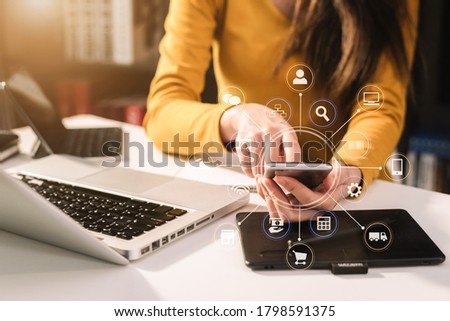 Social media and Marketing virtual icons screen of business women typing keyboard with laptop computer and smart phone at office.