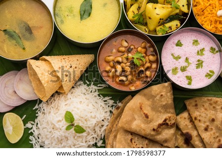 Maharashtrian food Thali or platter - Mumbai style Meal from Indian State Maharashtra includes, roti, rice, dal, sabji, sweet roti and rice, kadhi, Modak, papad etc Royalty-Free Stock Photo #1798598377