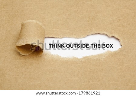 Think Outside The Box appearing behind torn brown paper. 