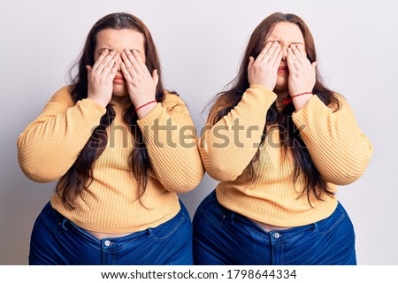 Young plus size twins wearing casual clothes rubbing eyes for fatigue and headache, sleepy and tired expression. vision problem 