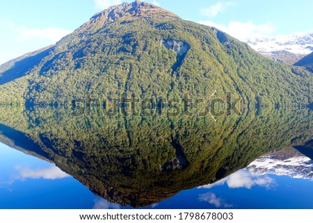 Mountain reflection in a lake, Millford Sounds, New Zealand.