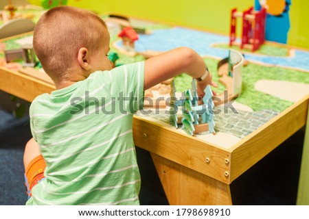 little caucasian boy playing educational games