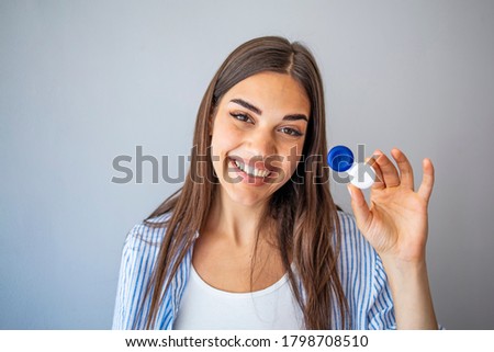 Woman Thinking to Choose Contact Lenses Over Eyeglasses. Girl considering the advantages and disadvantages of wearing contacts. Woman with Contact Lenses Case Royalty-Free Stock Photo #1798708510