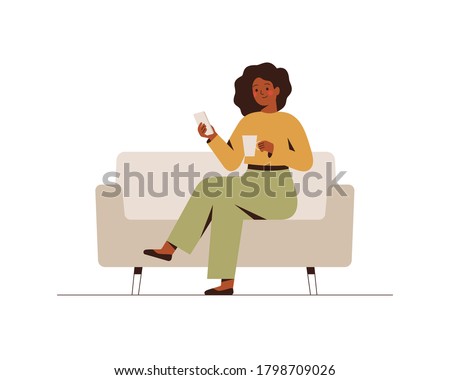 The black businesswoman is sitting on the couch with a mobile phone at the break time. Young dark skin girl drinking coffee and using a smartphone. Flat cartoon vector illustration. Royalty-Free Stock Photo #1798709026