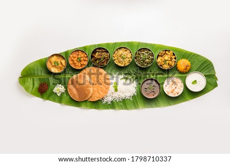 Traditional South Indian Meal or food served on big banana leaf, Food platter or complete thali.  selective focus Royalty-Free Stock Photo #1798710337